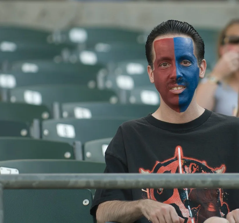 Portrait of a performer with half his face painted blue