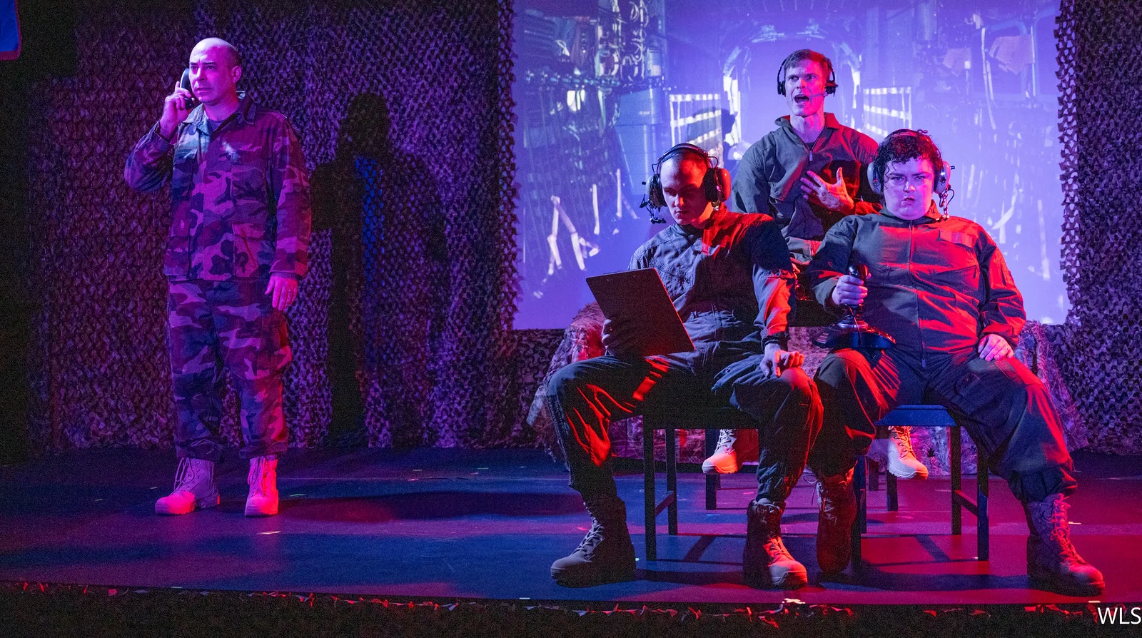Actors lit in red and blue during War in Pieces